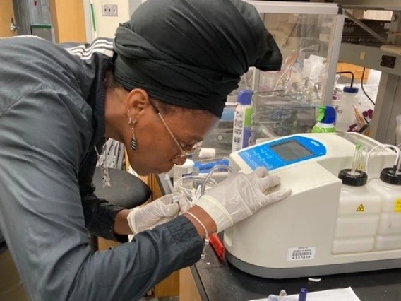 A graduate student at a lab bench