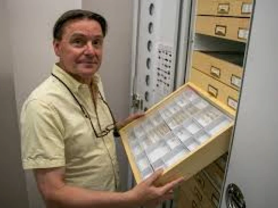 Picture of Gene Hall holding specimens